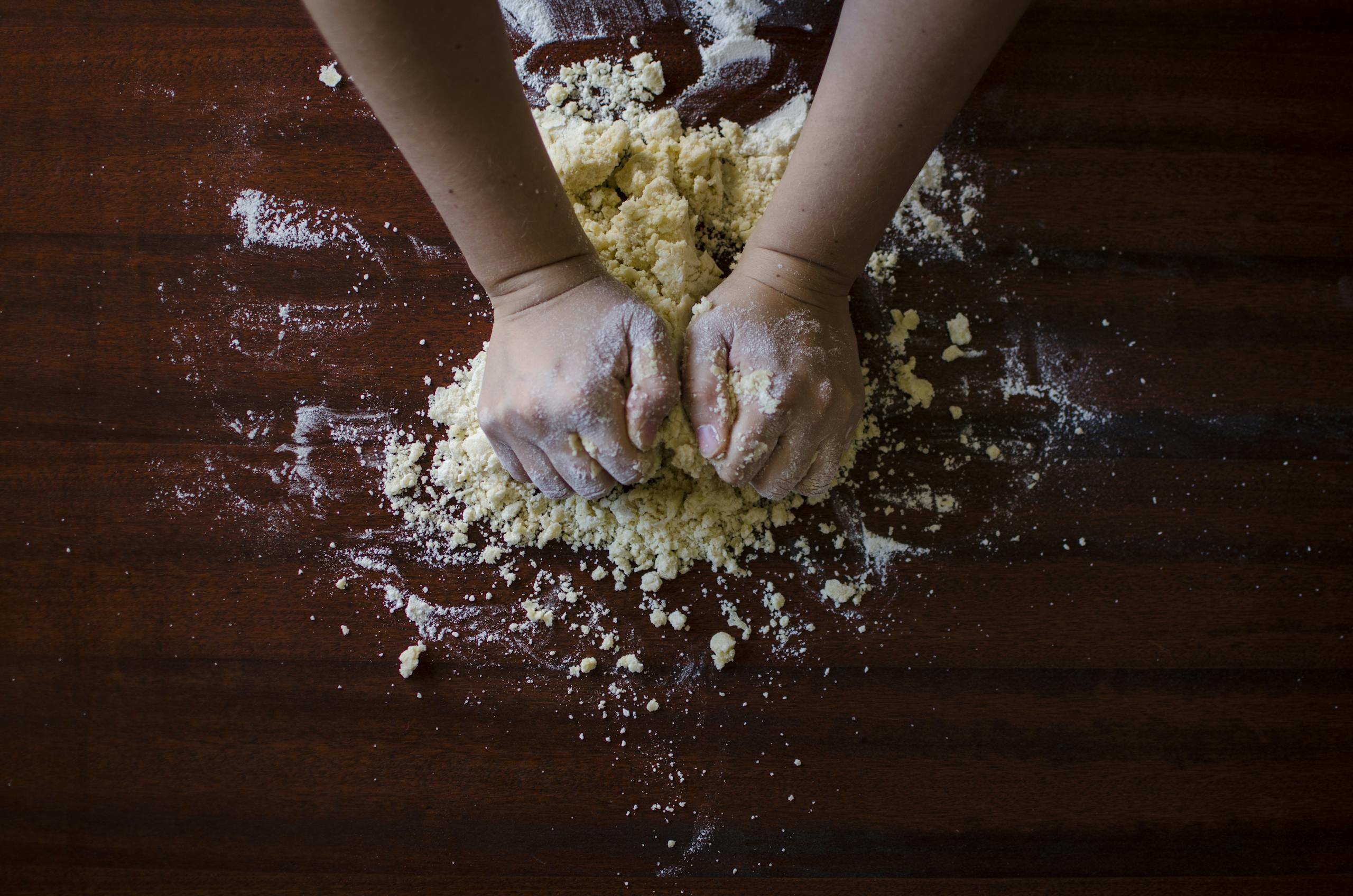 Person Mixing Dough